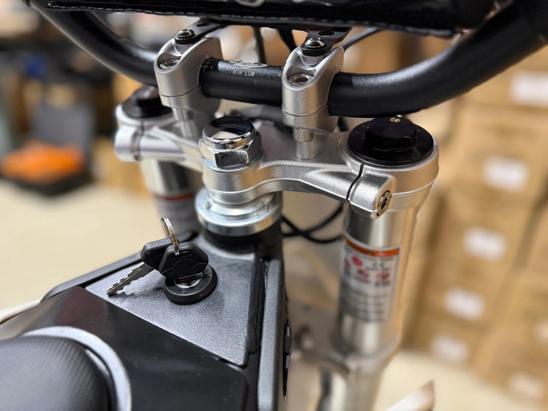 Close-up of a motorcycle's suspension system with visible branding.