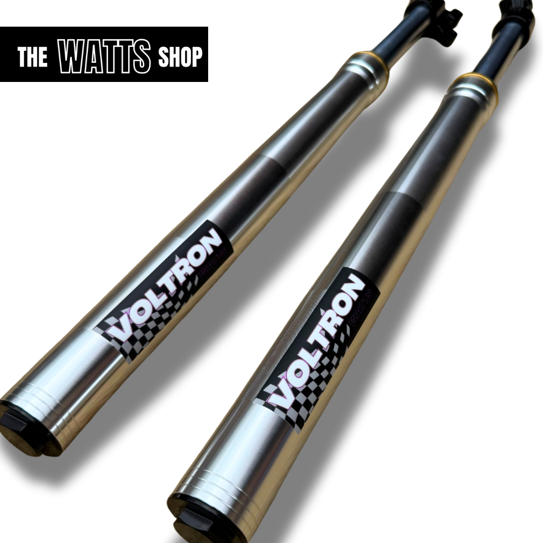 Two silver tuttio Soleil shock absorbers with 'Voltron' branding on a white background, featuring 'The Watts Shop' logo.