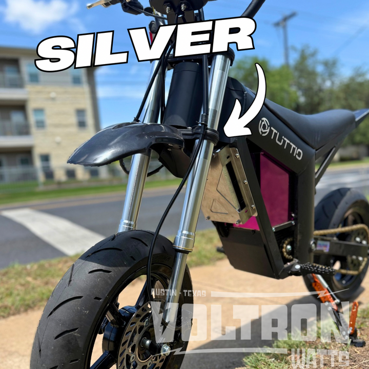 Motorcycle with 'SILVER' text and 'TUTTO' branding on a blurred background