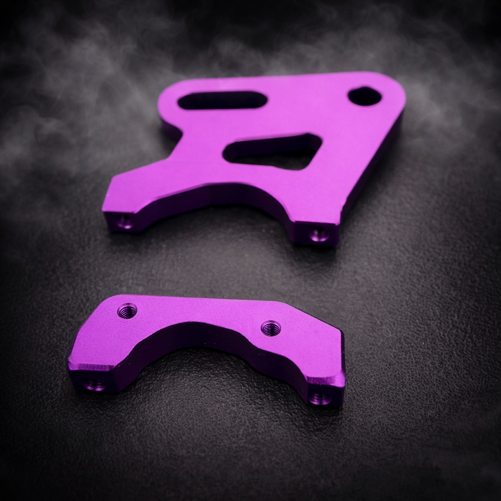 Two purple metal brackets on a dark textured background
