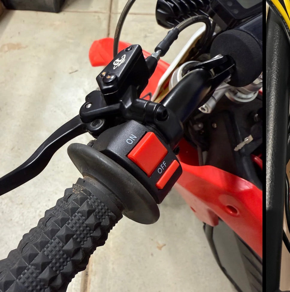 Close-up of a motorcycle handlebar with red switch and black grip