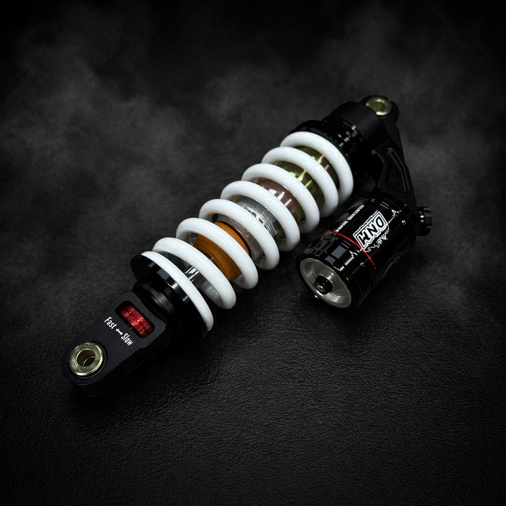 Motorcycle shock absorber on a dark textured background
