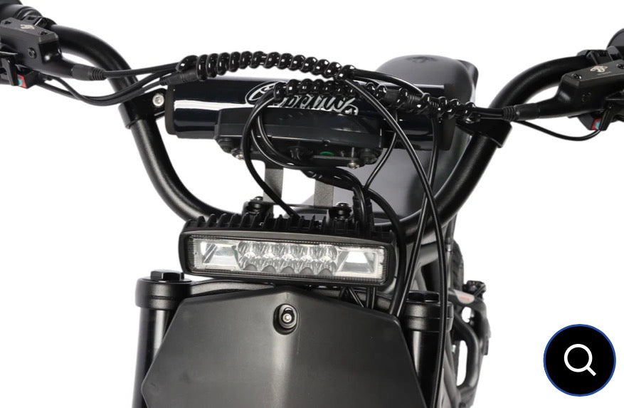 Close-up of a motorcycle's handlebar with visible branding on a white background