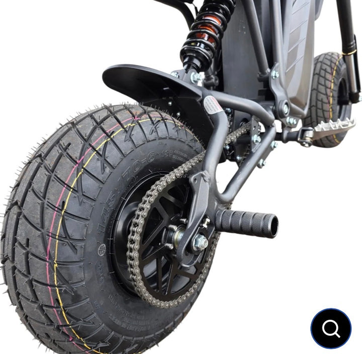 Close-up of a scooter wheel with tread pattern on a white background