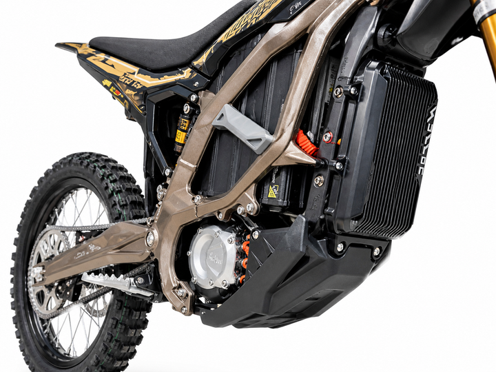 Close-up of a dirt bike with a focus on the chain and suspension system.