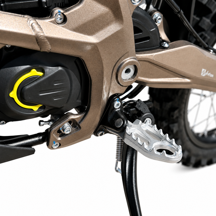 Close-up of a motorcycle's foot peg and engine area on a white background