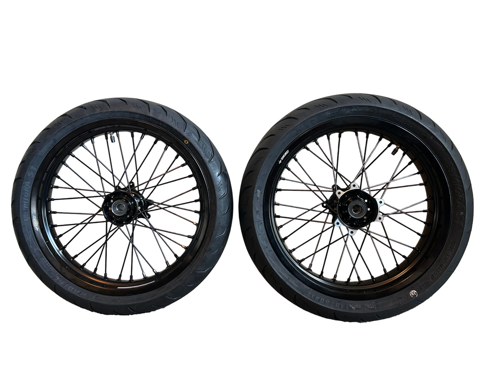 Two black motorcycle wheels on a white background