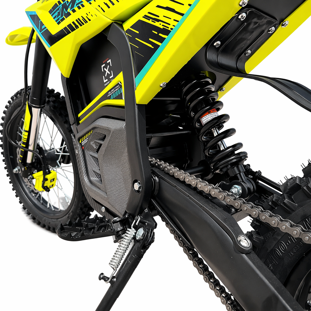 Close-up of a yellow and black dirt bike with visible branding on a white background