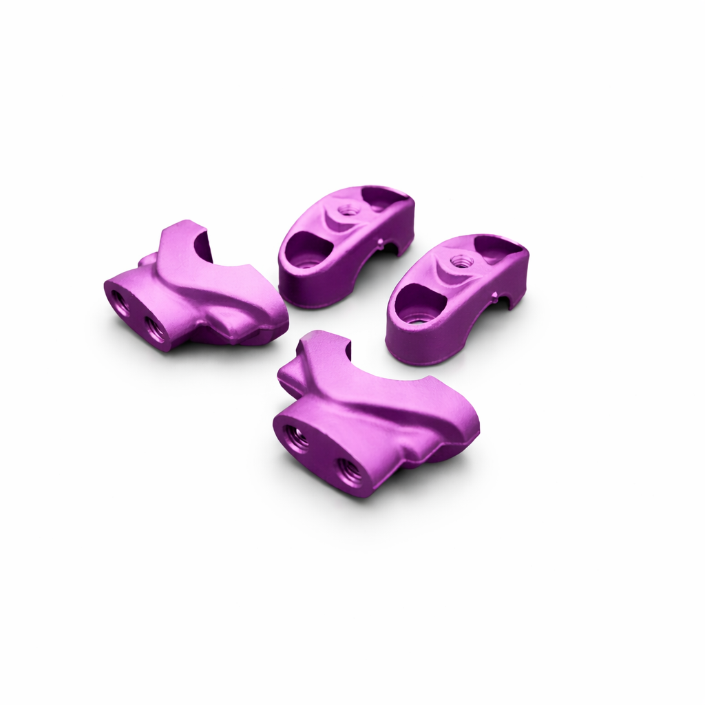 Four purple metal components on a white background