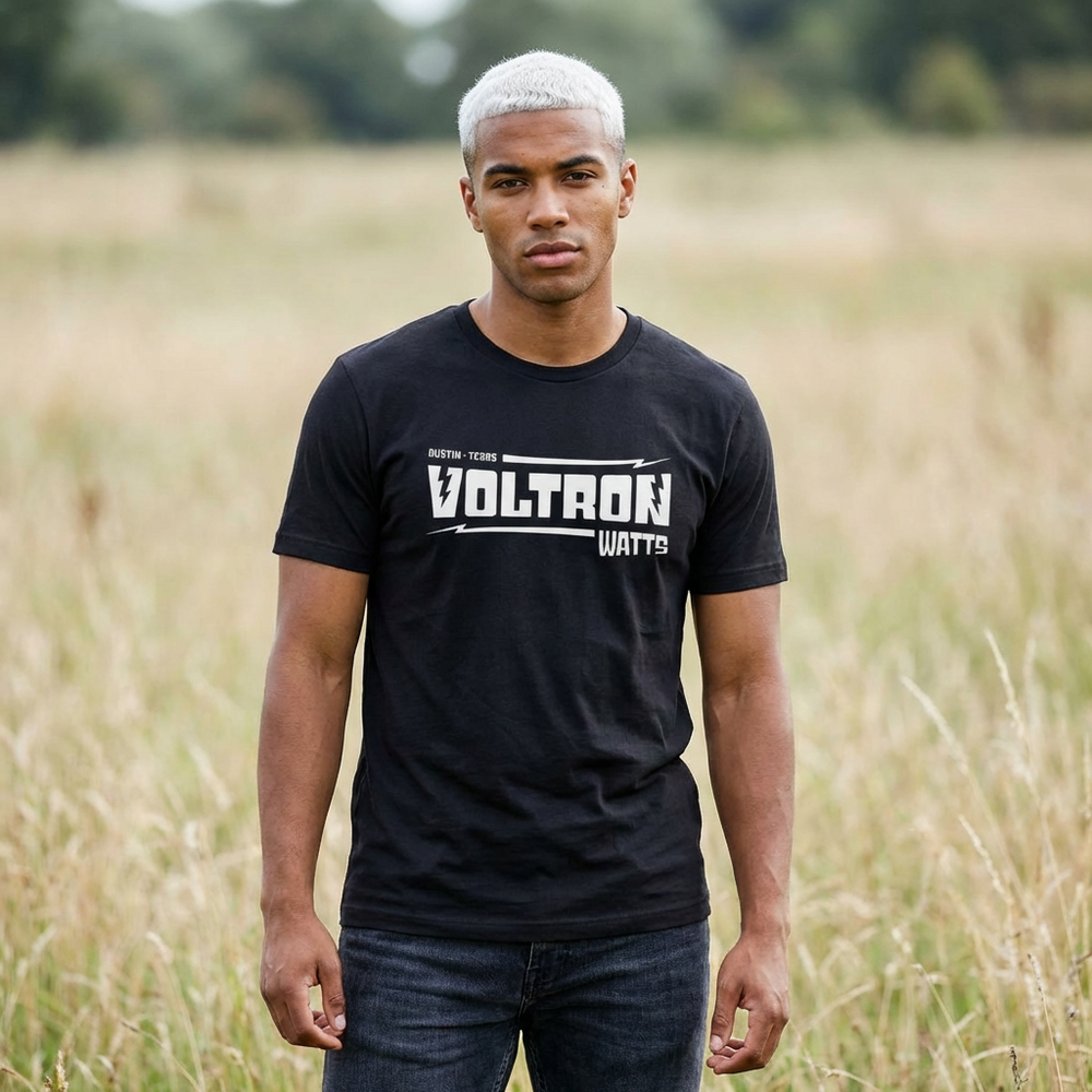 Man wearing a black t-shirt with 'Voltron Watts' text in a field