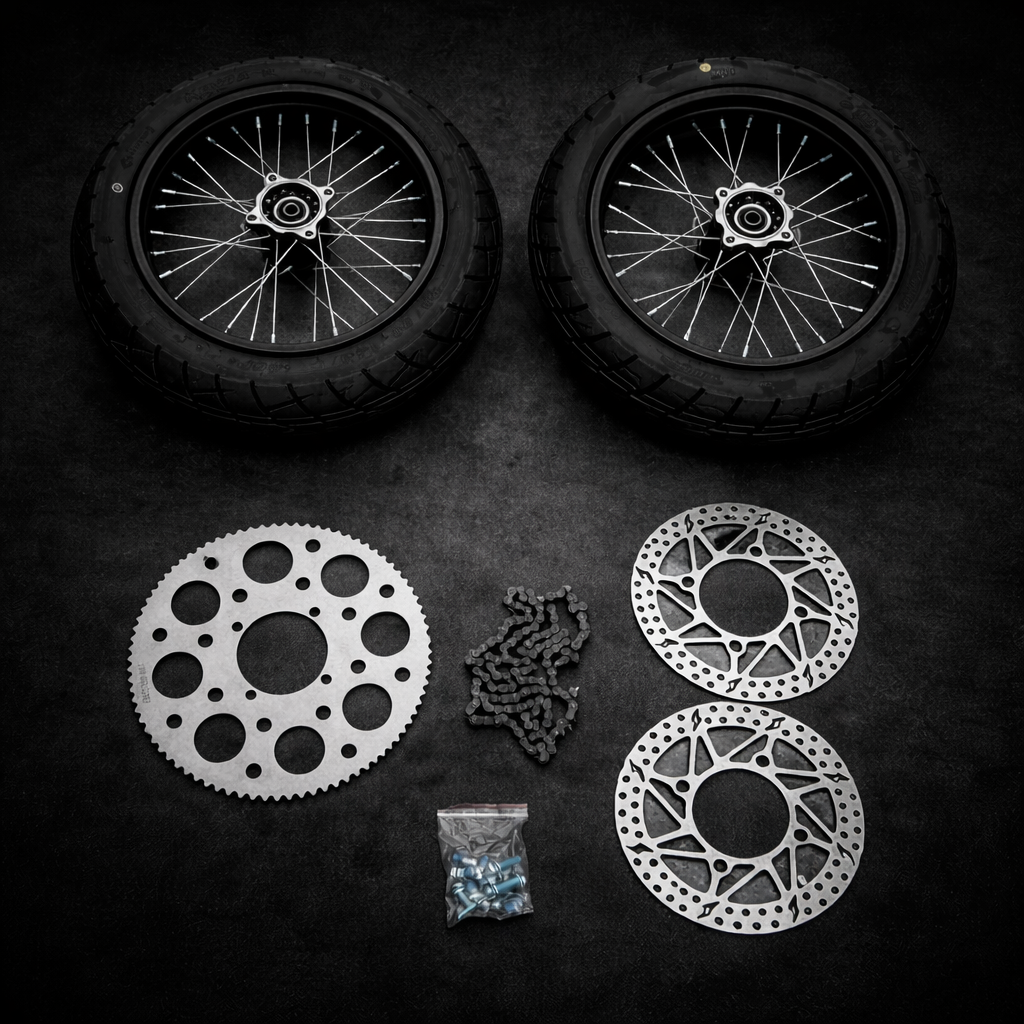 Motorcycle wheels, sprockets, and chain on a dark surface
