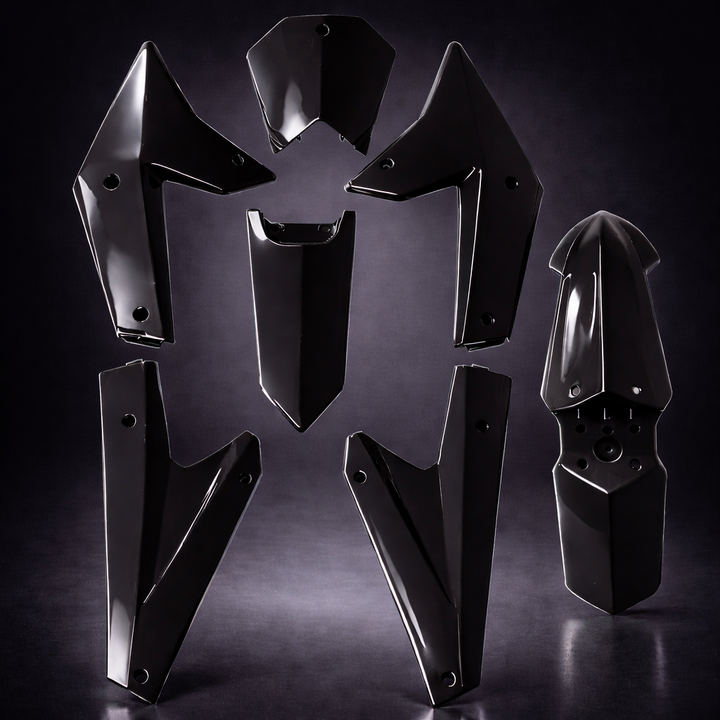 Black metal motorcycle parts on a dark background