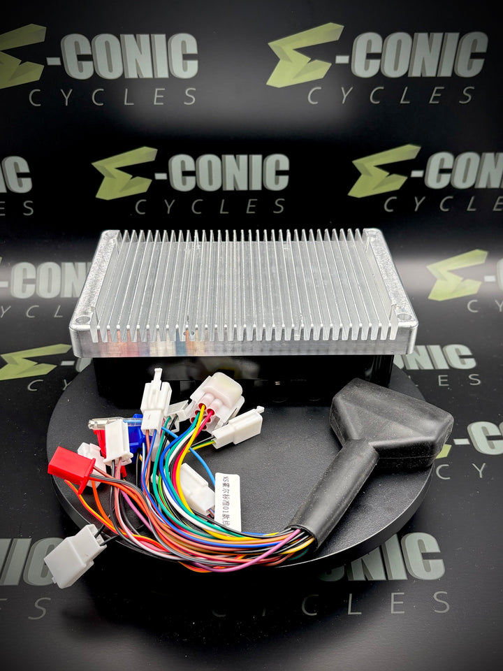 Electronic components with wiring on a black surface, branded 'e-Conic Cycles'.