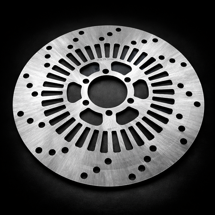 Metallic disc with a textured surface on a black background