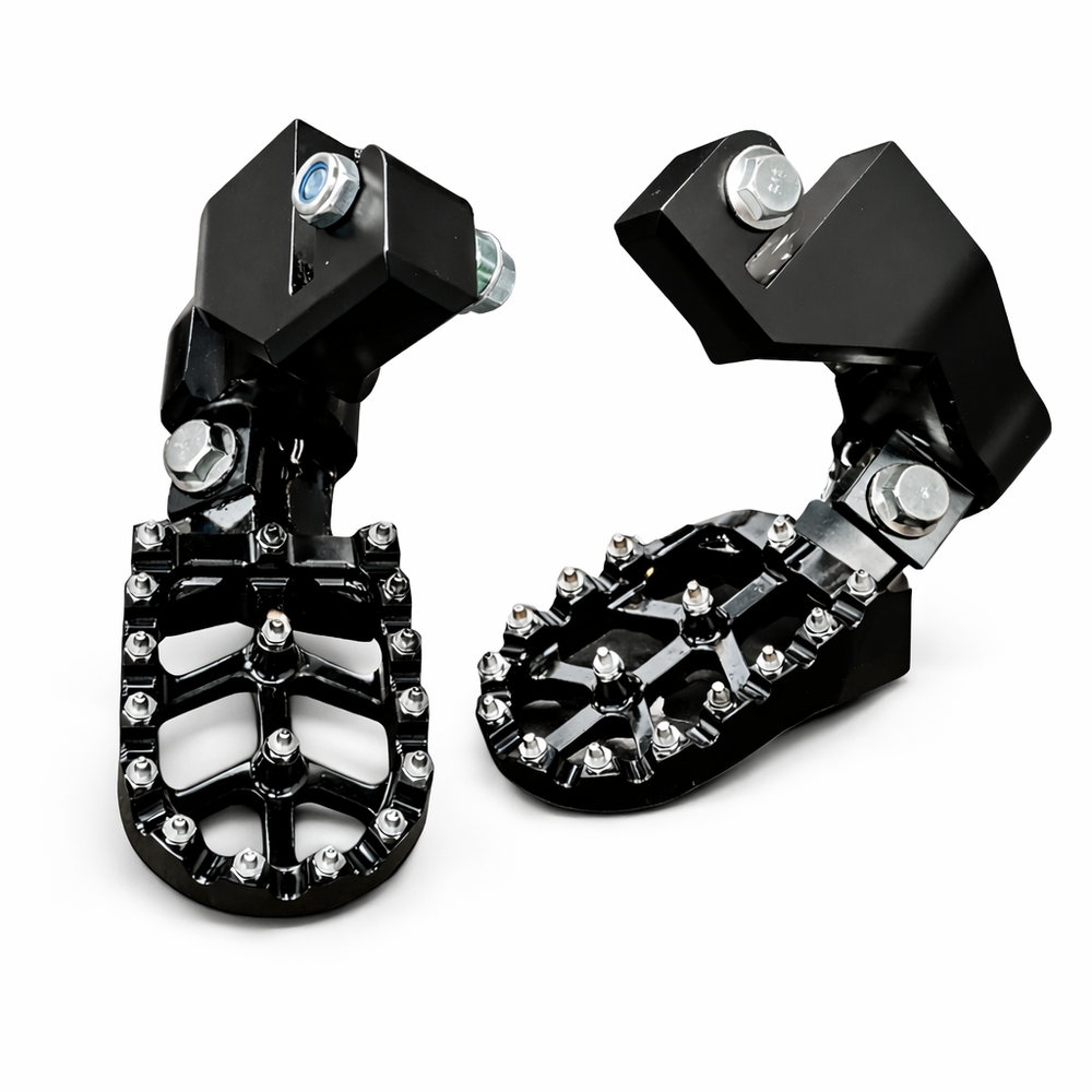 Pair of black motorcycle foot pegs with metallic accents on a white background