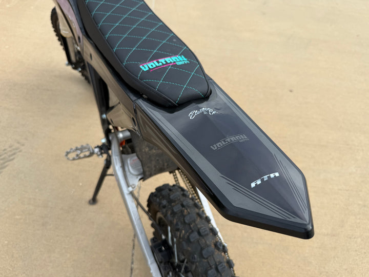 Motorcycle seat and fender on a sandy background