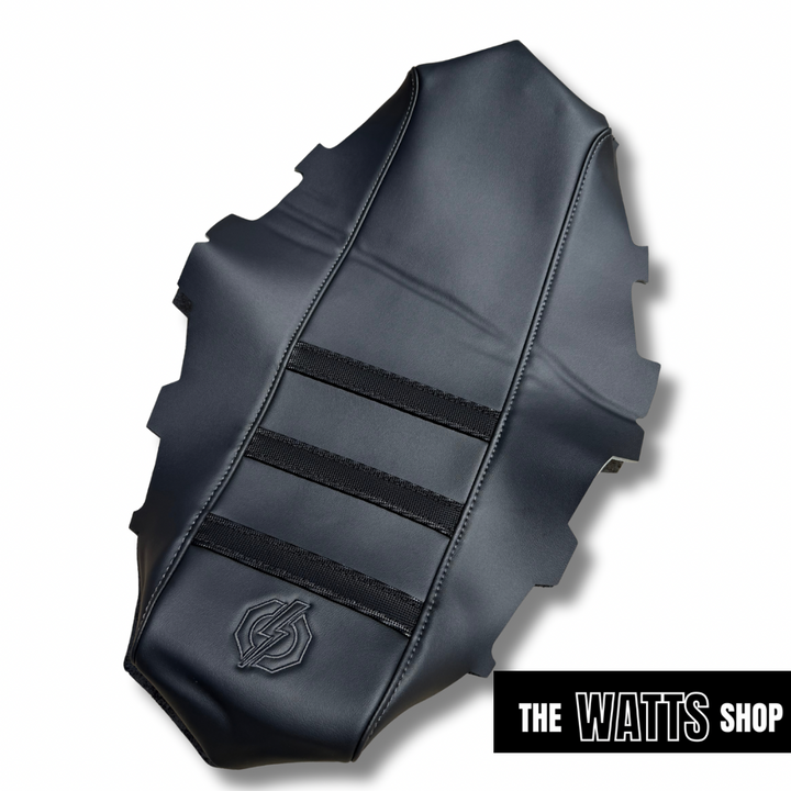 Black leather motorcycle seat with 'The Watts Shop' branding on a white background